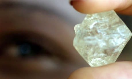 A worker at the Botswana Diamond Valuing Company displays a rough diamond