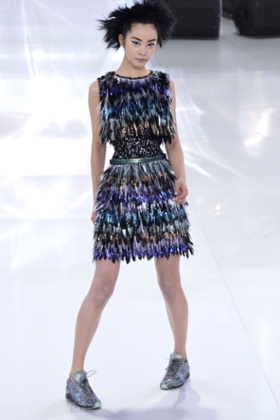 Karl Lagerfeld sends a Chanel model down the Paris catwalk in trainers in January 2014.