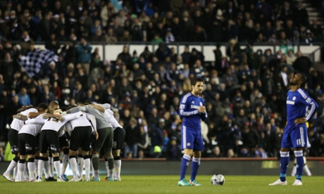 The Derby players huddle up as Cesc Fabregas and Didier Drogba wait to kick-off.