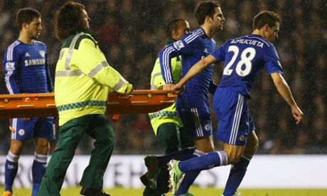 Chelsea’s Cesc Fabregas and Cesar Azpilicueta help the medical team with the stretcher.