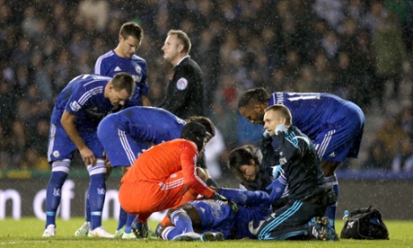 Concerned Chelsea players look on as Kurt Zouma is tended to by the Chelsea medical staff.