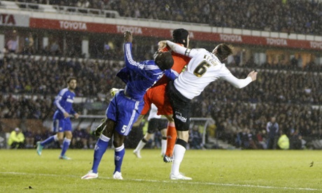 Chelsea's Kurt Zouma falls to the turf after being accidentally caught in the head by Petr Cech.