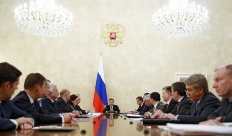 Russias Prime Minister Dmitry Medvedev (C) chairs a meeting with representatives of the government finance and economy units, Central Bank management, management of major fuel, energy and metal companies in Moscow on December 17, 2014.