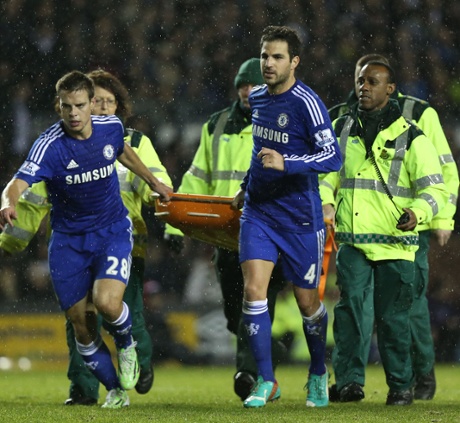 César Azpilicueta  and Cesc Fàbregas help carry Kurt Zouma off the field on a stretcher.