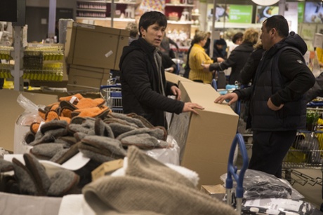 Men wait in a line to pay for their purchases at the IKEA store on the outskirts of Moscow, Russia, Wednesday, Dec. 17, 2014.