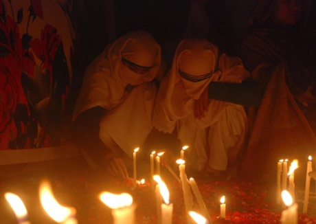 People light candles in memory of victims of the Taliban attack on the Army Public School, along with others in a rally in  Peshawar.