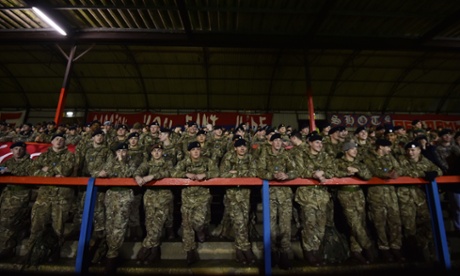 Members of the British armed forces watch the Game of Truce in Aldershot.