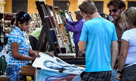 Tourists look at posters for sale in Havana on 18 December 2014.