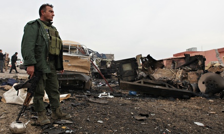 Kurdish fighter at bomb site