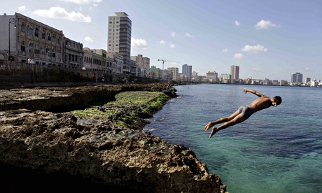 Cuba boy jumps into the water at the Malecon in Havana