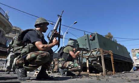 Lebanese army soldiers open fire during clashes with Islamic militants in the northern port city of Tripoli in September. Fighting from Syria's civil war is increasingly spilling over into northern Lebanon.