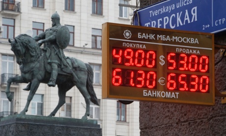 A board showing currency exchange rates, in front of a monument to Prince Yury Dolgoruky who founded Moscow in 1147 on December 1.