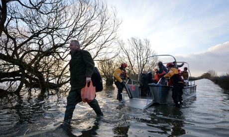 Residents disembark a boat after being transported from the cut-off village of Muchelney in Somerset