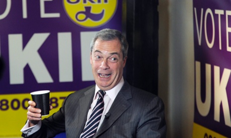 Nigel Farage laughs as he holds a coffee cup