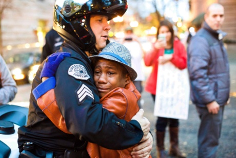'The cop appears to be comforting the boy. After all the anger, all the divisions, here is a moment of human reconciliation. What nonsense.'