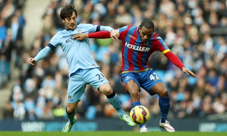 Manchester City’s David Silva tussles with Crystal Palace’s Jason Puncheon.