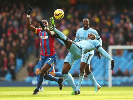 Eliaquim Mangala elongates his leg just enough to flick the ball away from Yannick Bolasie of Crystal Palace