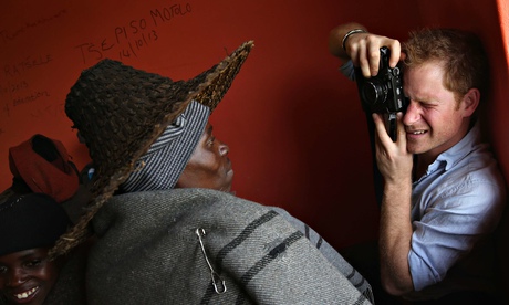 Britain's Prince Harry takes a photograp