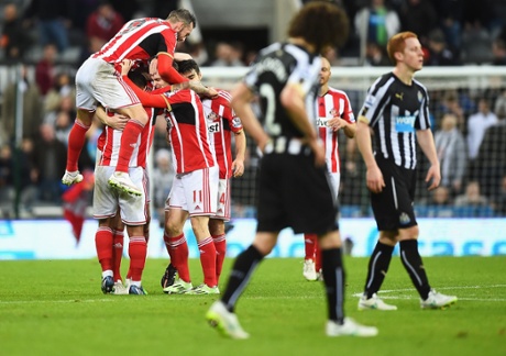 Sunderland players mob Adam Johnson as they celebrate victory