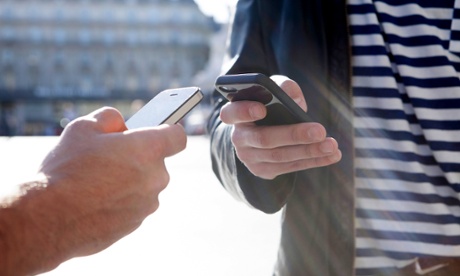 Two men holding iPhones.