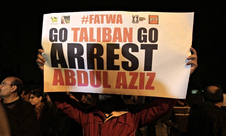 A man holds a sign during a protest near the Red Mosque in Islamabad.