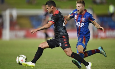 Newcastle Jets Andrew Hoole applies pressure to Adelaide United's Fabio Ferreira.