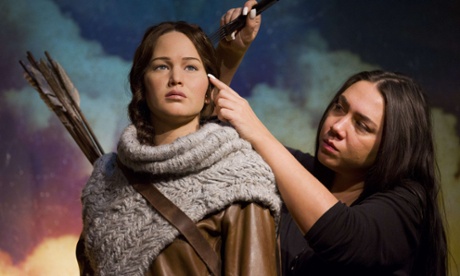 Hair stylist Gemma Sim poses putting the finishing touches J-Law's statue.