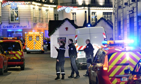 Police officers at the Christmas market in Nantes, France, after a man drove a van into the crowd