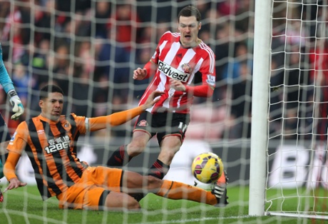 Sunderland's Adam Johnson (R) scores the opening goal against Hull City at The Stadium of Light.