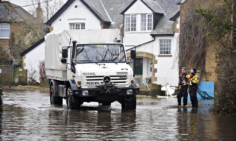 A Red Cross off road vehicle delivers fire wood to the village of Muchelney in Somerset after it was
