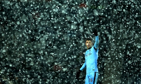 Manchester City's Martin Demichelis tries to signal his team as heavy snow falls at The Hawthorns.