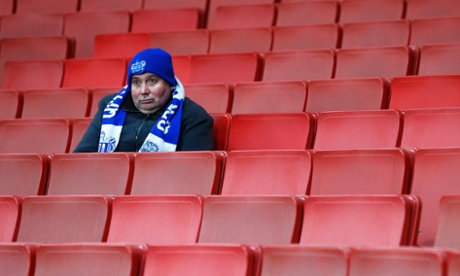 A QPR fan looks over a wet Emirates Stadium before the start.