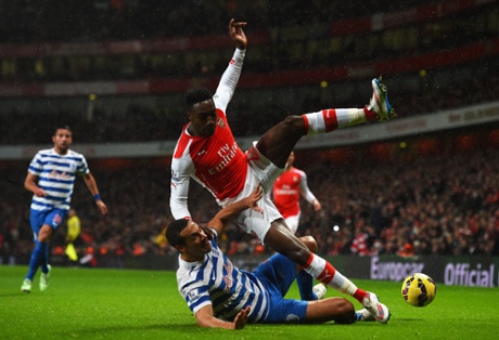 Rio Ferdinand brings down Arsenal's Danny Welbeck.