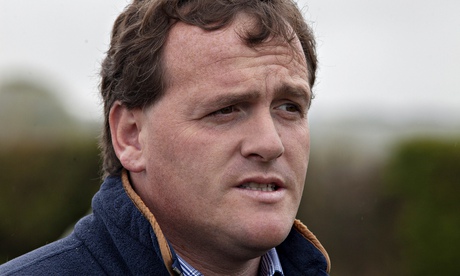 Richard Hannon watches some of his horses at early morning exercise at his stables near Marlborough