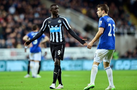 Papiss Demba Cisse exchanges words with Seamus Coleman.