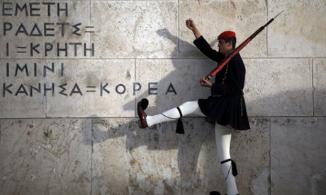 A Greek presidential guard performs a ceremonial march at the monument of the unknown soldier in front of the parliament building in Athens on Saturday.