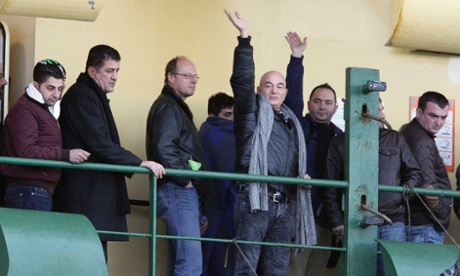 People wave from aboard the 