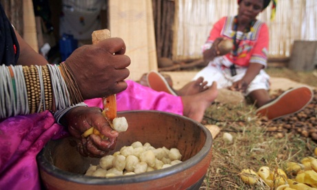 Women crush marula kernels