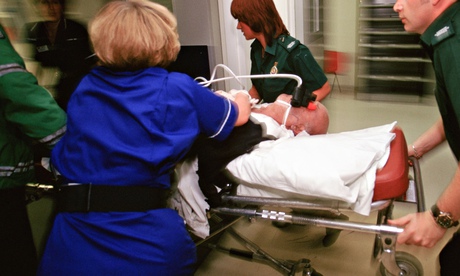 Ambulance crew bring a patient to the A&E ward
