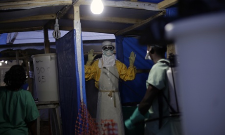 An MSF Ebola heath worker is sprayed as he leaves the contaminated zone at the Ebola treatment centre in Gueckedou, Guinea in November.