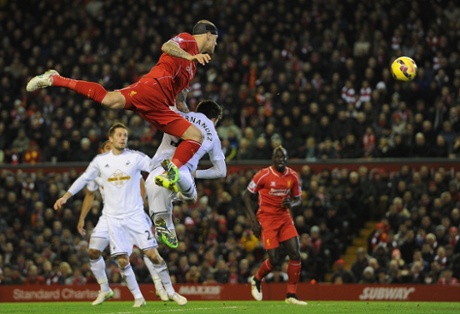 Martin Skrtel gets up high but directs his header straight at Fabianksi.