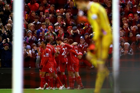 Fabianksi cuts a forlorn figure as the Liverpool players celebrate.