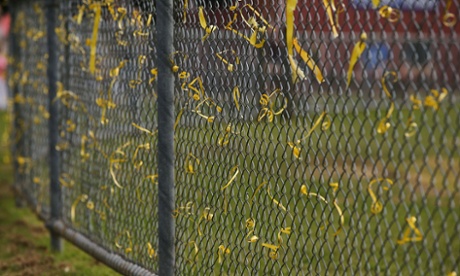 Yellow ribbons tied to an oval fence in Tyabb during a memorial for Luke Batty