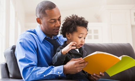 Father and son reading together