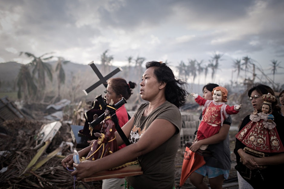 Philippe Lopez’s best photograph a procession after Typhoon Haiyan hit