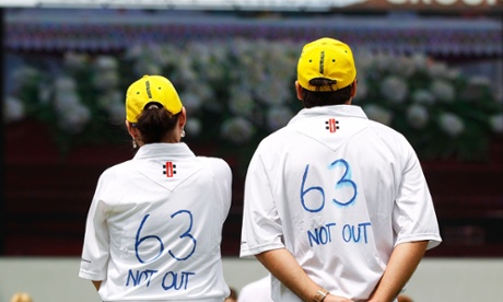 Cricket fans pay their respects while watching the funeral service held in Macksville for Phillip Hughes