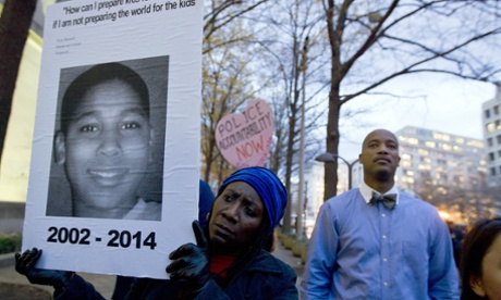 Tomiko Shine holds up a picture of Tamir Rice, the 12 year old boy fatally shot on Nov. 22 by a police officer, during a protest in response to a grand jury's decision in Ferguson, Missouri