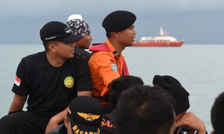 Members of an Indonesian search and rescue team (Badan SAR National or Basarnas) are ferried out to a ship to conduct search operations at sea for missing AirAsia flight QZ8501 from Manggar in East Belitung on December 30, 2014.