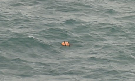 This aerial view taken from an Indonesian search and rescue aircraft over the Java Sea shows floating debris spotted in the same area as other items being investigated by Indonesian authorities as possible objects from missing AirAsia flight QZ8501 on December 30, 2014.