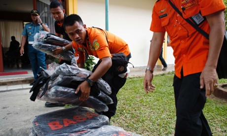 Search and rescue workers prepare to load body bags onto a flight to Kalimantan in Indonesia.